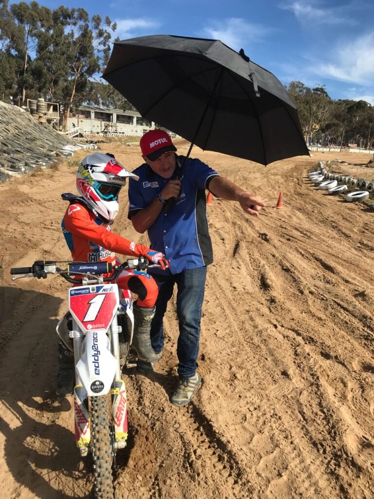 Dean Hoffman coaching a young rider on the track